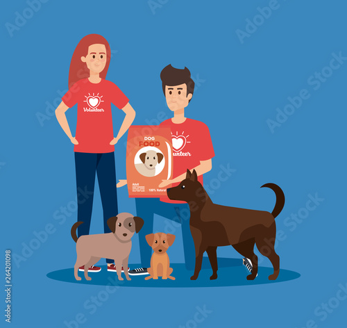 girl and boy volunteers with dogs and food