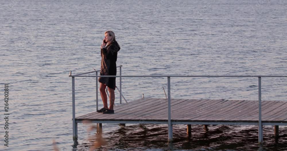 Girl on the pier with the phone