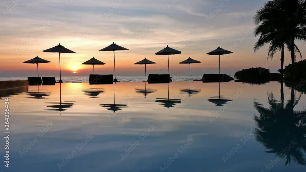 Swimming pool with umbrella and chair on sea view background Swimming pool with umbrella and chair on sea view background