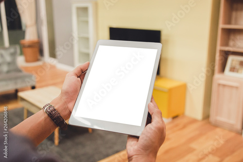 Mockup tablet on businessman hands empty display on home table with blur background. - Image - Image