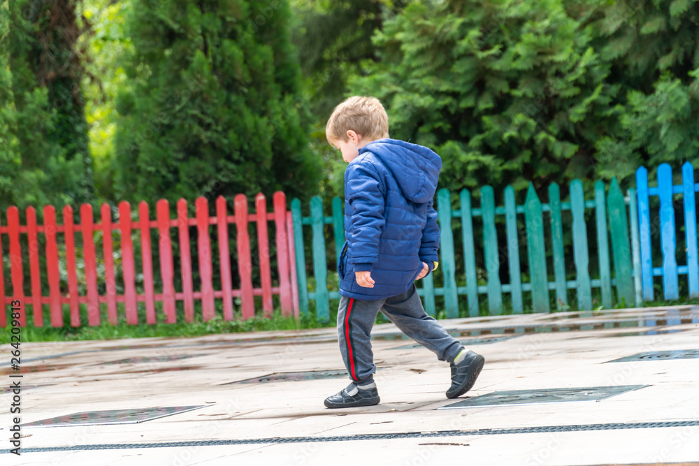 Small child scratching his bottom at a park Small child scratching his bottom at a park