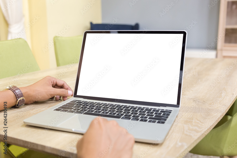 Mockup image of a businessman using laptop with blank white desktop screen working in home- Image Mockup image of a businessman using laptop with blank white desktop screen working in home- Image
