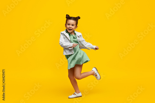 Stylish child smiling and dancing photo