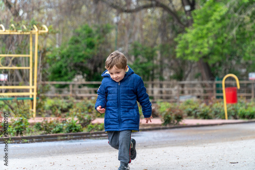 Small child running in a park © nikolay100