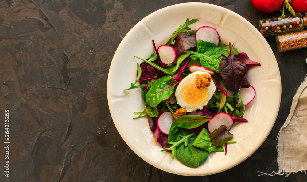 salad with radishes, egg and mix leaves lettuce, snack. food background. top view salad with radishes, egg and mix leaves lettuce, snack. food background. top view