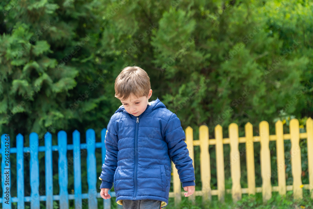 Small child walking and looking at his feet Small child walking and looking at his feet
