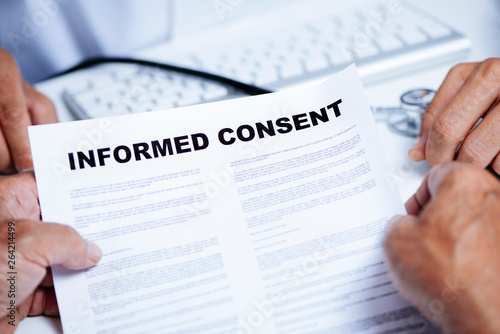Obraz na plátně senior man reading an informed consent