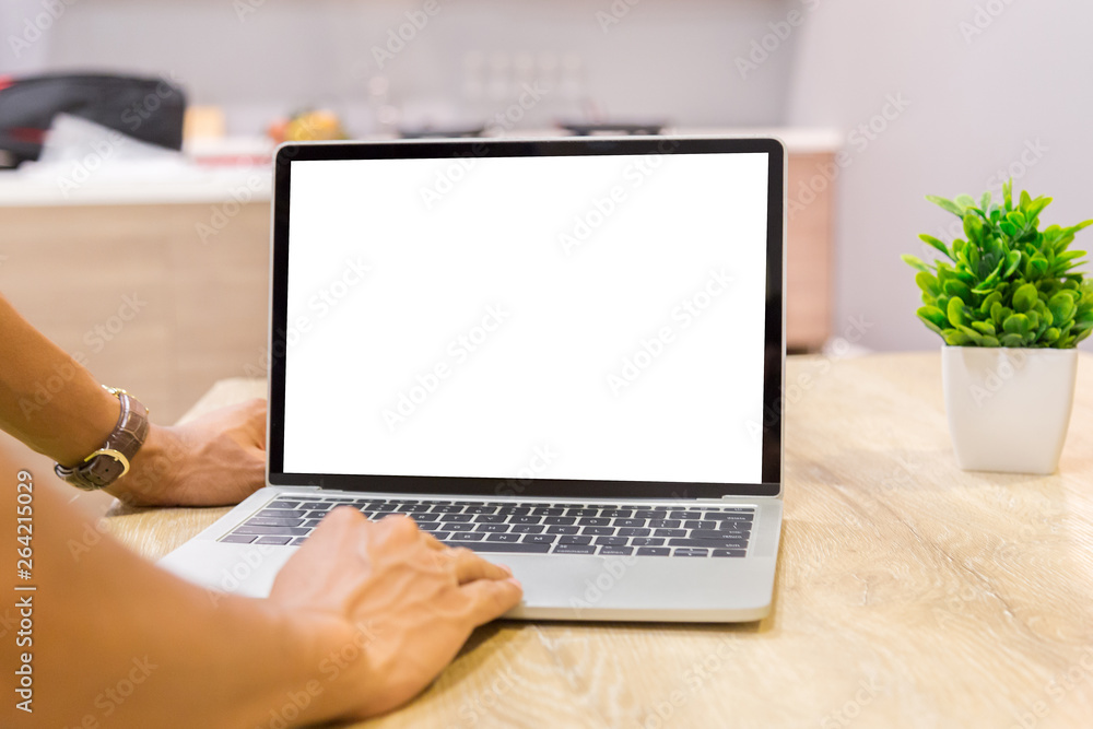 Mockup image of a businessman using laptop with blank white desktop screen working in home- Image Mockup image of a businessman using laptop with blank white desktop screen working in home- Image