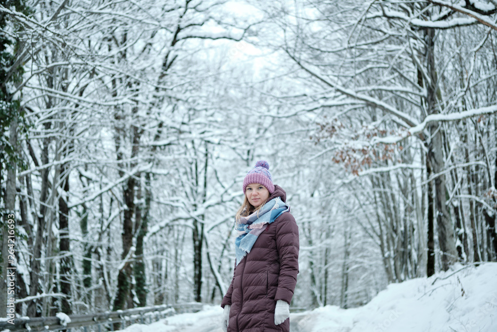 Beautiful blond girl posing in snow mountain forest Beautiful blond girl posing in snow mountain forest