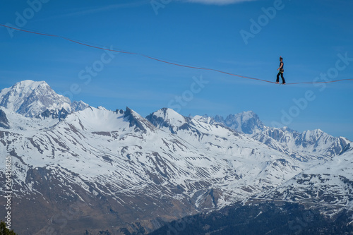 a man walking on a highline in the French Alps, Auvergne-Rhône-Alpes, Bourg-Saint-Maurice, France © Fred Marie
