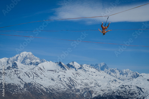 a man hanging on a highline in the French Alps, Auvergne-Rhône-Alpes, Bourg-Saint-Maurice, France © Fred Marie