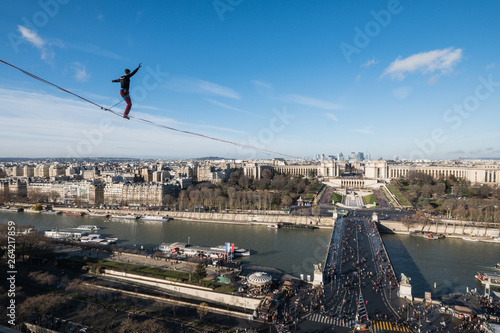 a man walk on a highline between Eiffel tower and Trocadero, Île de France, Paris, France photo