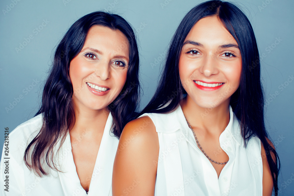 cute pretty teen daughter with mature mother hugging, fashion style brunette, lifestyle people concept close up cute pretty teen daughter with mature mother hugging, fashion style brunette, lifestyle people concept close up
