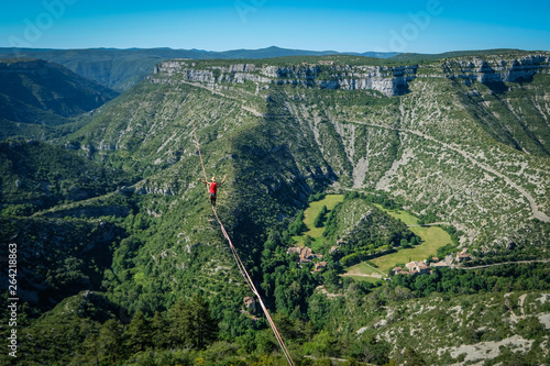 Obraz na plátně a man walking on the longest slackline ever in Navacelles circus (world humanity