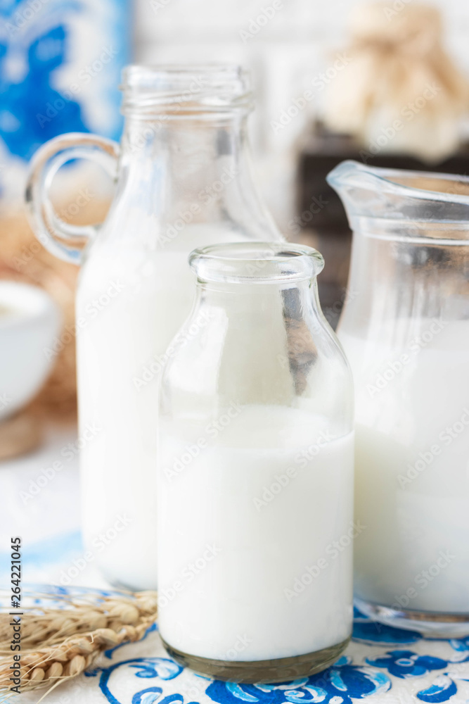 Milk in bottles of various shapes and sizes Milk in bottles of various shapes and sizes