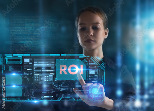 The concept of business, technology, the Internet and the network. A young entrepreneur working on a virtual screen of the future and sees the inscription: ROI