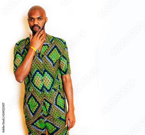 portrait of young handsome african man wearing bright green national costume smiling gesturing, entertainment stuff close up photo