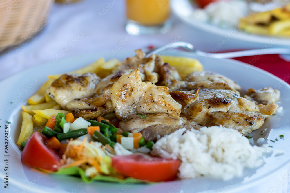 Grilled chicken breast, French fries and vegetables Grilled chicken breast, French fries and vegetables