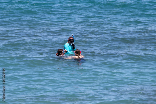 Family snorkeling in the ocean © alan