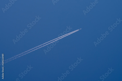 Airliner contrail in perfect blue sky