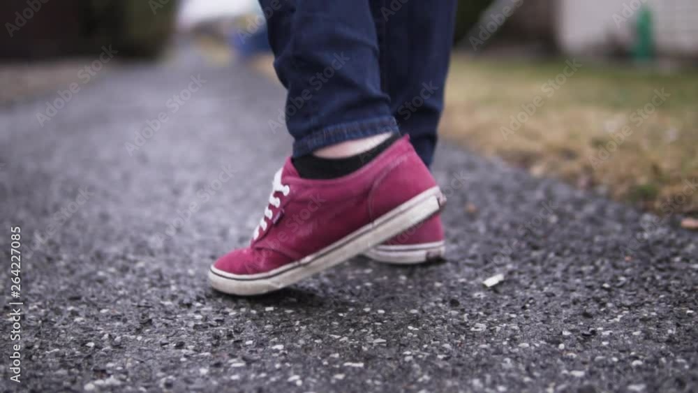 Purple shoes on a girl on a sidewalk in the rain. Purple shoes on a girl on a sidewalk in the rain.