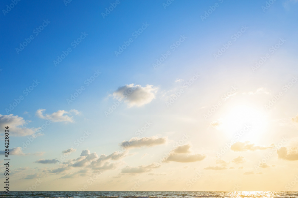 Beautiful early morning sunrise over the sea the horizon,blue sky background texture with white clouds sunset.