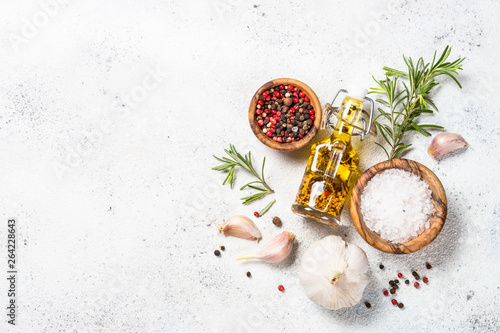 Tableau sur toile Spices, herbs and olive oil over white stone table.
