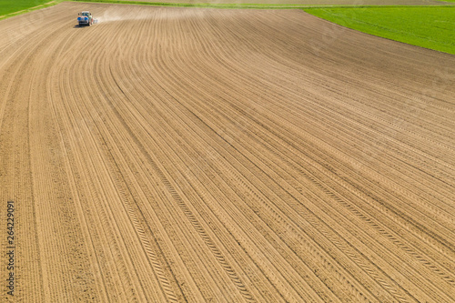 farming maize sowing tractor on dry field in southern germany birds eye view