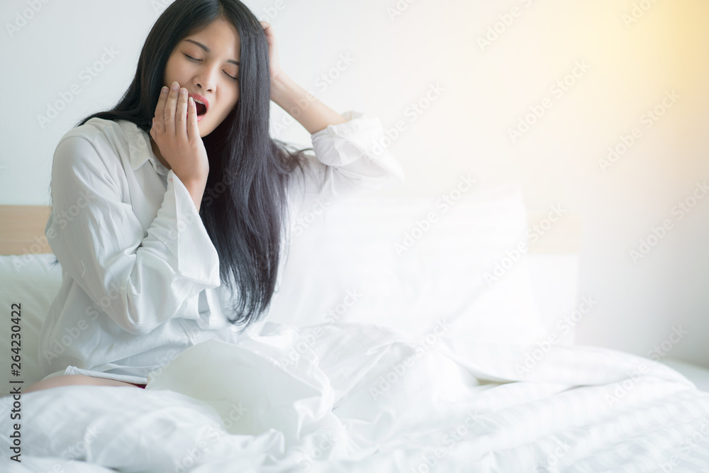 Beautiful young woman wake up and stretch oneself in the morning at bedroom Beautiful young woman wake up and stretch oneself in the morning at bedroom