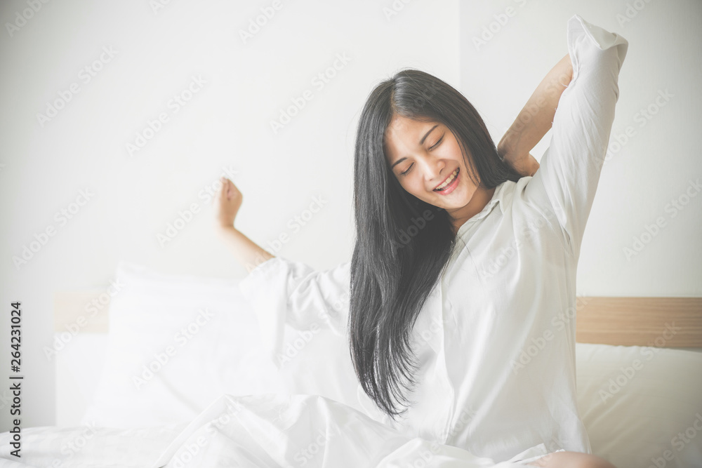 Beautiful young woman wake up and stretch oneself in the morning at bedroom Beautiful young woman wake up and stretch oneself in the morning at bedroom