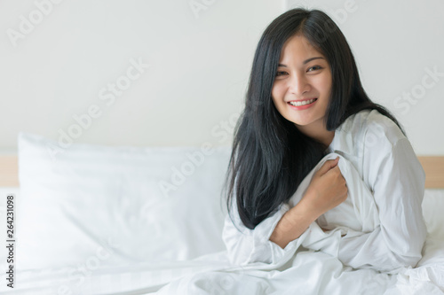 Beautiful young woman wake up in the morning at bedroom