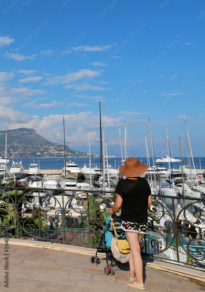 French Riviera - Saint Jean Cap Ferrat harbour - tourist admiring the boats