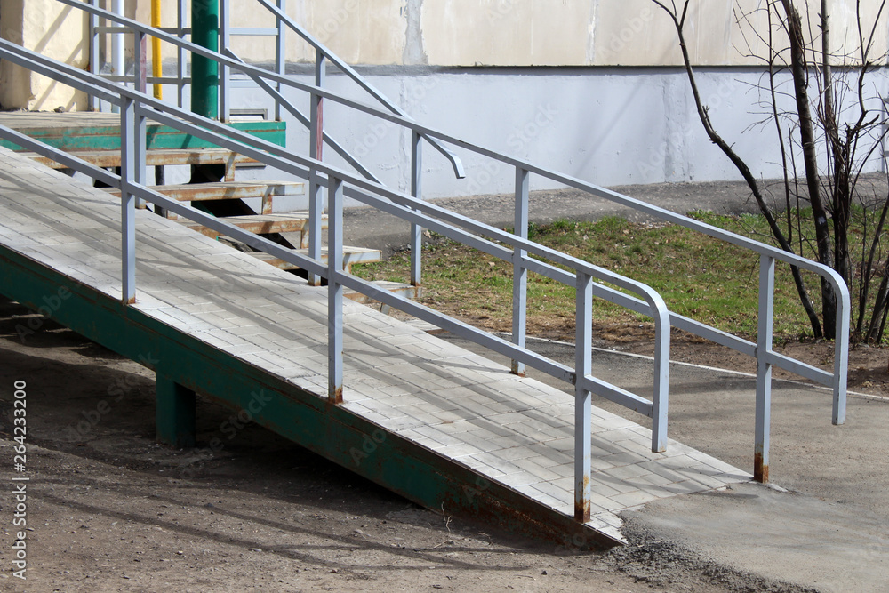 A wheelchair ramp, an inclined plane installed in addition to or