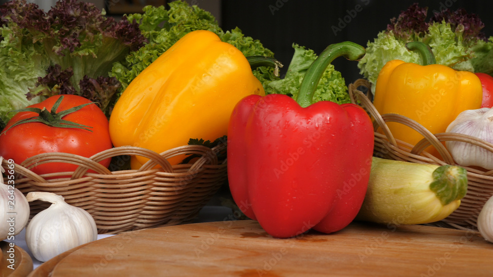 a background of many vegetables including pepper tomatoes garlic mushrooms vegetables on a wooden board