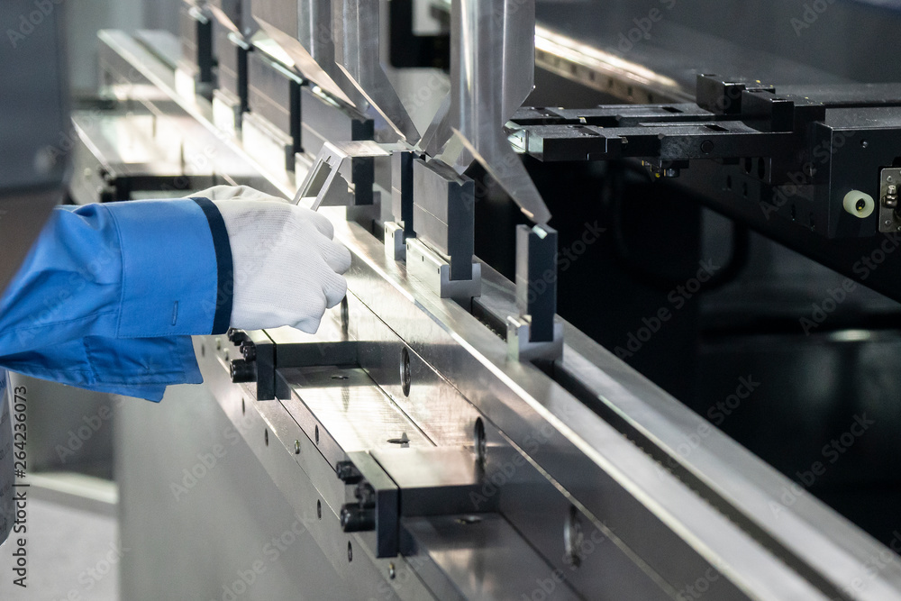 The technician operator use hydraulic bending machine. The sheet metal manufacturing process. The technician operator use hydraulic bending machine. The sheet metal manufacturing process.