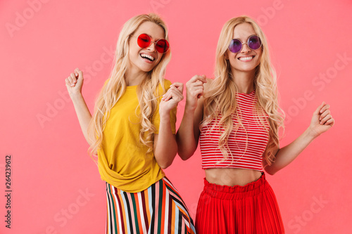 Picture of Pleased blonde twins in sunglasses having fun