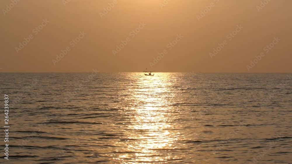 sunset in the sea has a boat. sunset in the sea has a boat.
