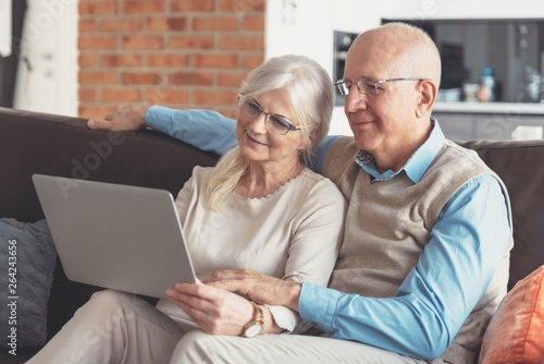 Senior couple browsing the internet together photo