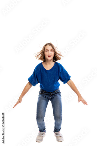 Laughing teen girl in a jump. Isolated on white background, vertical.