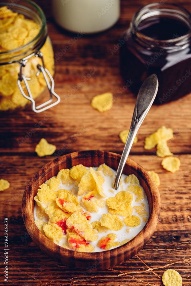 Breakfast with corn flakes, milk and berry syrup Breakfast with corn flakes, milk and berry syrup