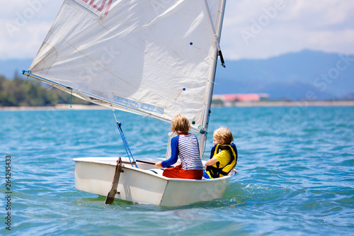 Child sailing. Kid learning to sail on sea yacht. photo