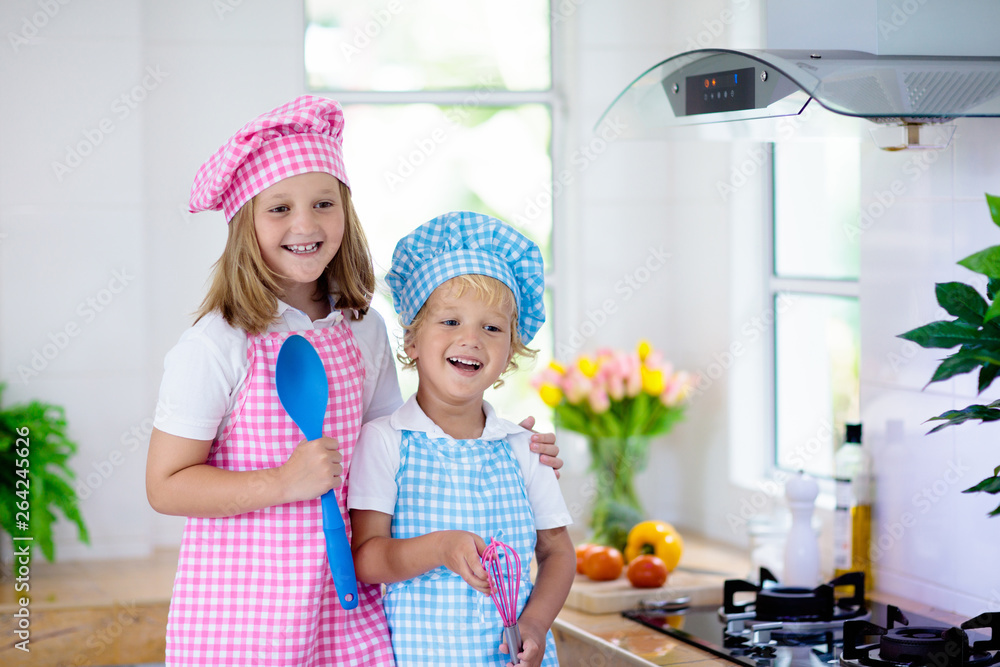Kids cook in white kitchen. Children cooking. Kids cook in white kitchen. Children cooking.