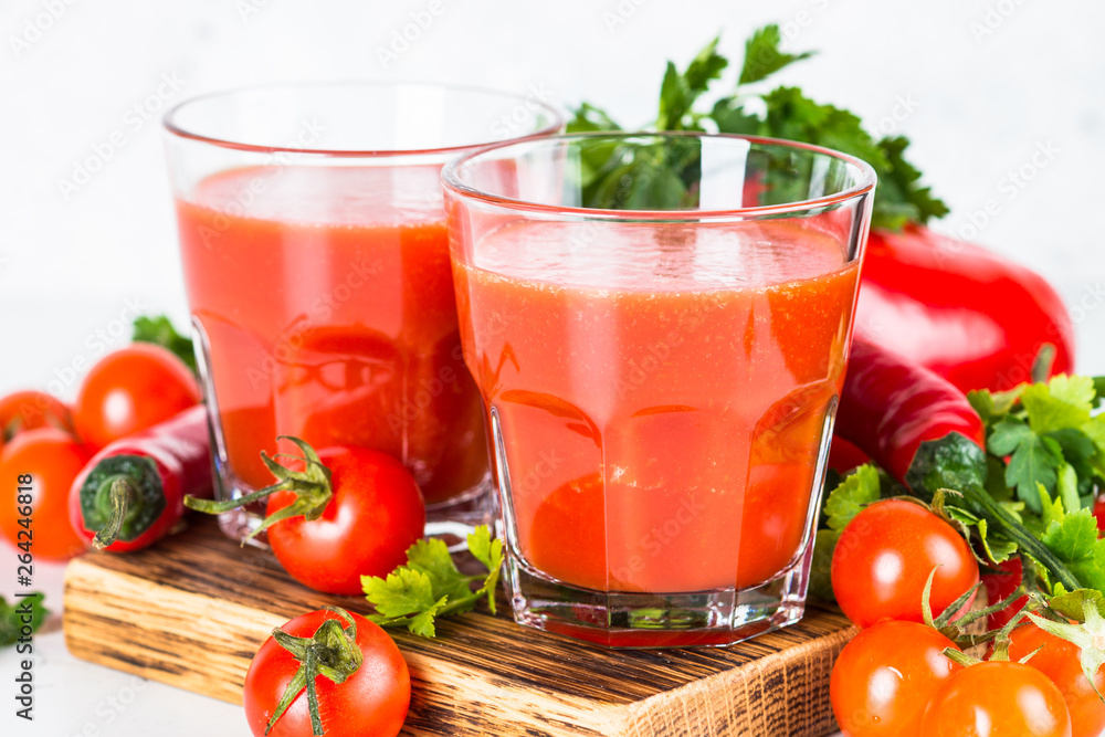 Tomato vegetable juice in glass on white. Tomato vegetable juice in glass on white.