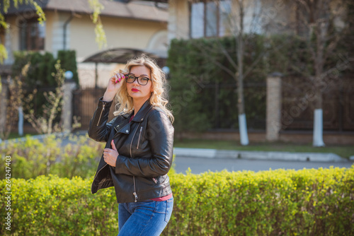Fashionable woman in glasses wear leather jacket and jeans, casual trend  © T.Den_Team