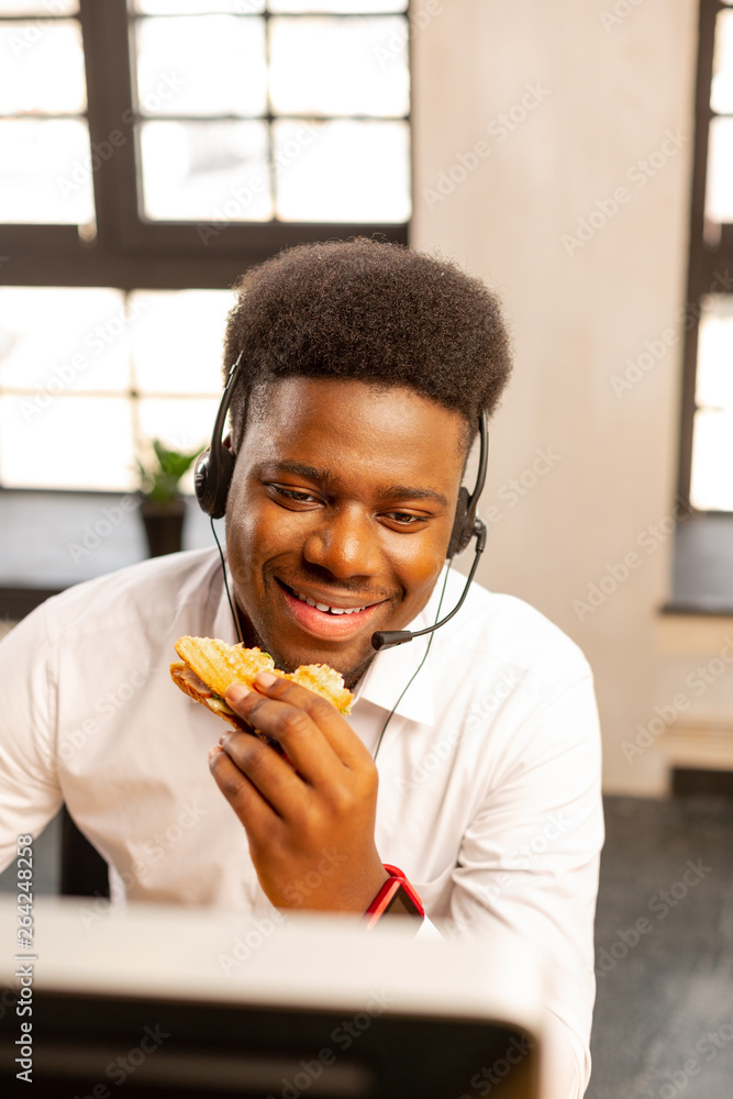 Joyful nice man working in the call centre Joyful nice man working in the call centre