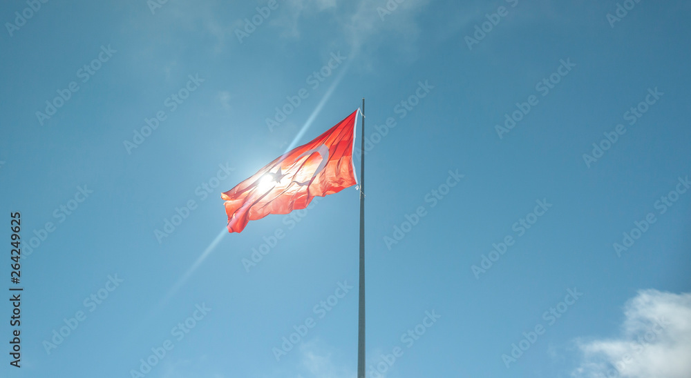 Turkish flag waving in cloudy blue sky. TURKEY
