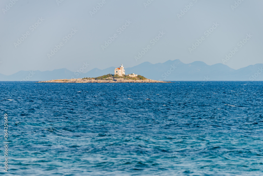 Beautiful summer seascape with lighthouse on the island in Orebic, Peljesac peninsula, Dalmatia, Croatia