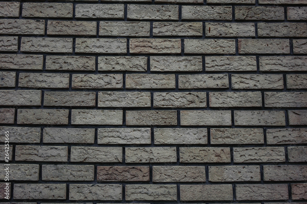 white wall of bricks with a gray tint brick background