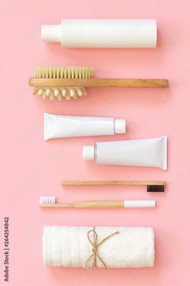Set of eco cosmetics products and tools for shower or bath Bamboo toothbrush, natural brush, white bottles, towel accessories for body, face and teeth care on pink background. Top view Flat lay Set of eco cosmetics products and tools for shower or bath Bamboo toothbrush, natural brush, white bottles, towel accessories for body, face and teeth care on pink background. Top view Flat lay