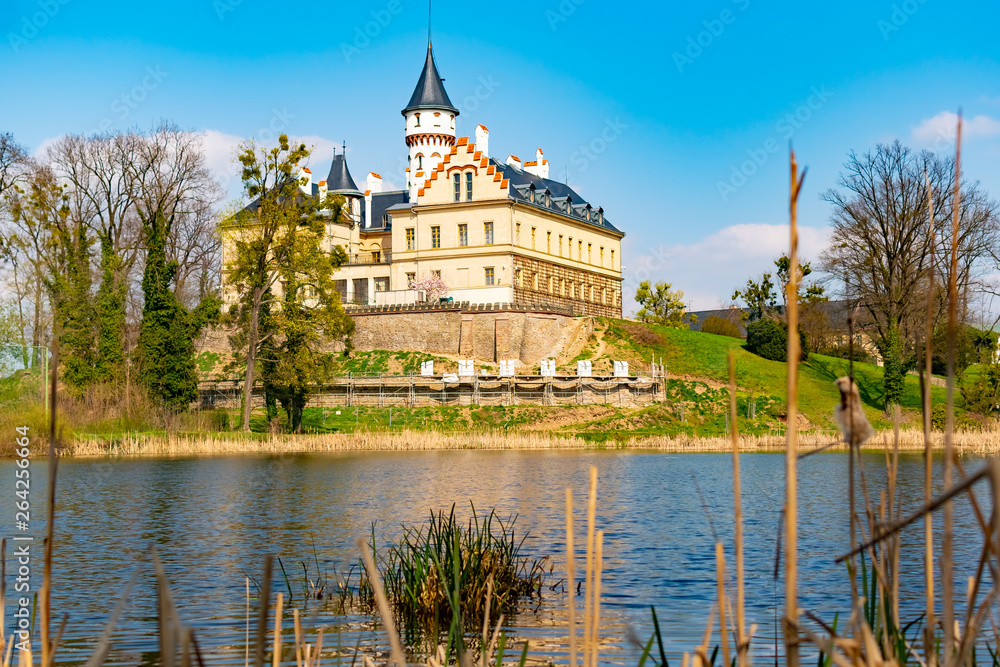 Renaissance old castle Radun near Opava city mirrored in a lake with reflections in water, Czech Republic